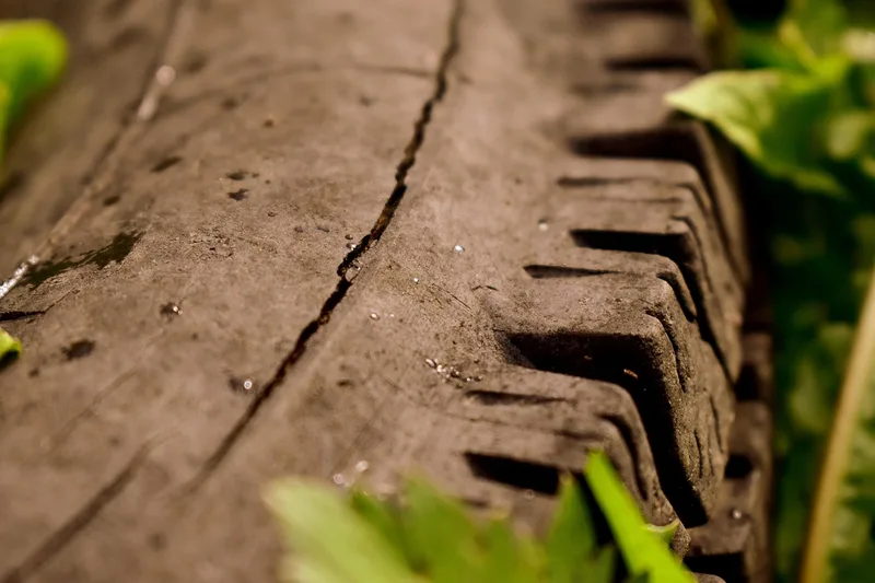 Close-up of a crack running across the rubber of an old tire
