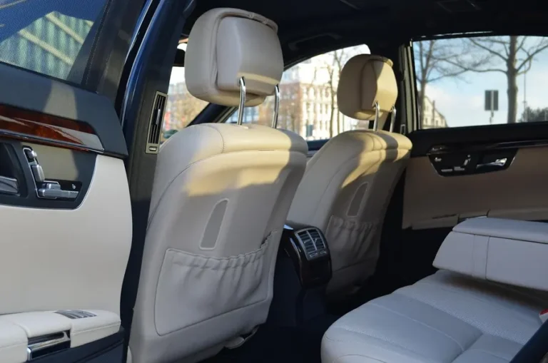 cream leather rear seats and wood trim inside a luxury car cabin