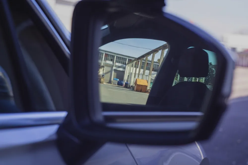 Side mirror housing and glass seen from the driver seat