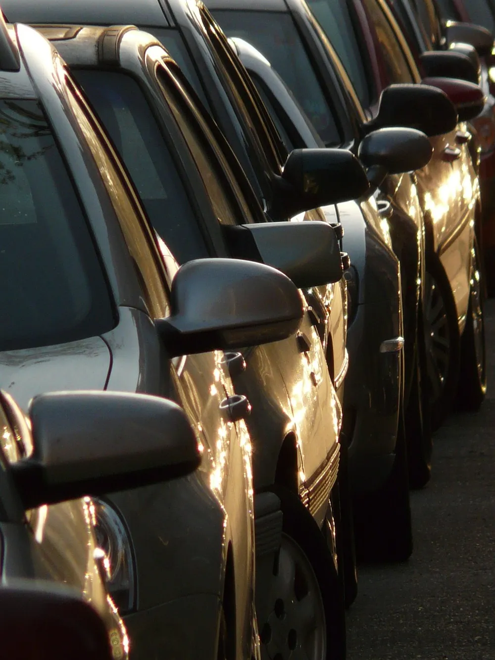 Side mirror housings on a row of parked cars
