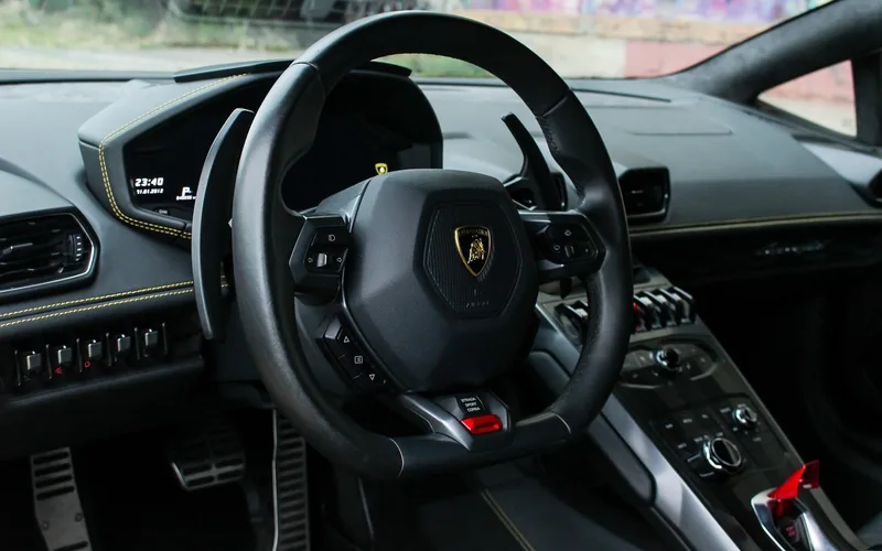 Lamborghini Huracan interior Lamborghini Huracan interior showing the steering wheel badge and digital dashboard