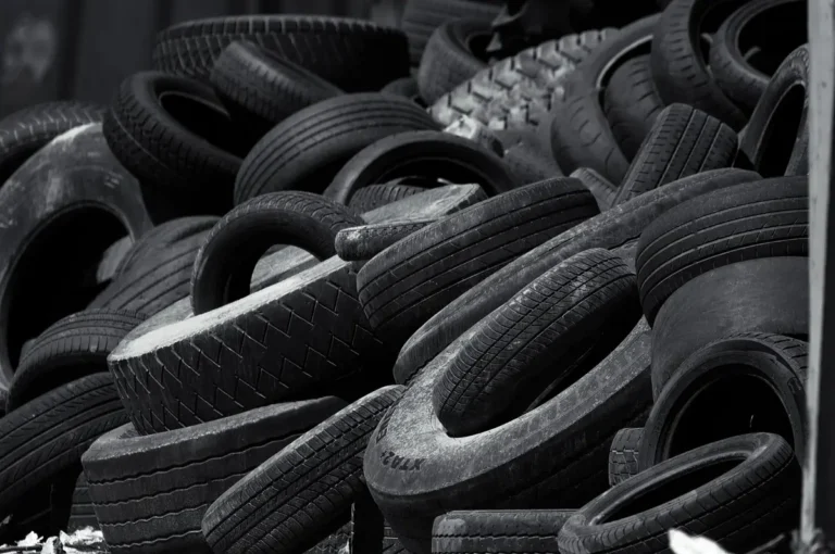 Pile of used car tires in black and white