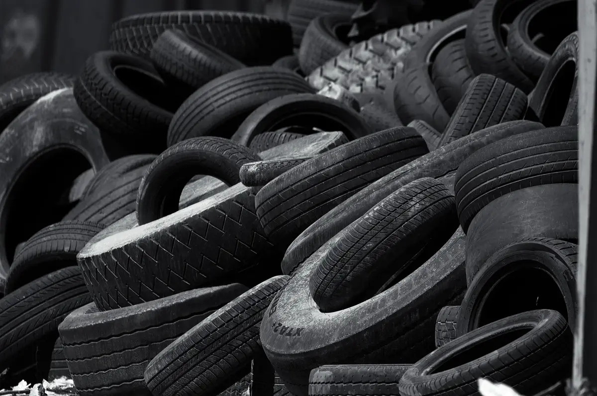 Pile of used car tires in black and white