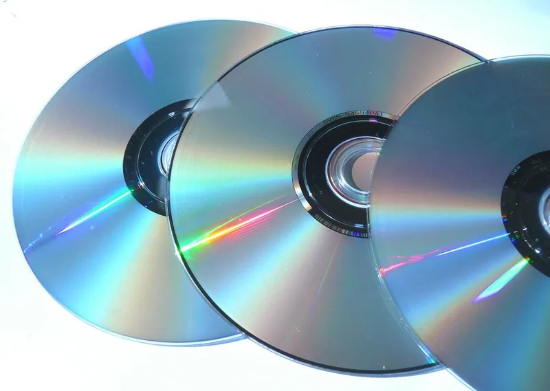 Three compact discs overlapping, showing the shiny laser-reading surface