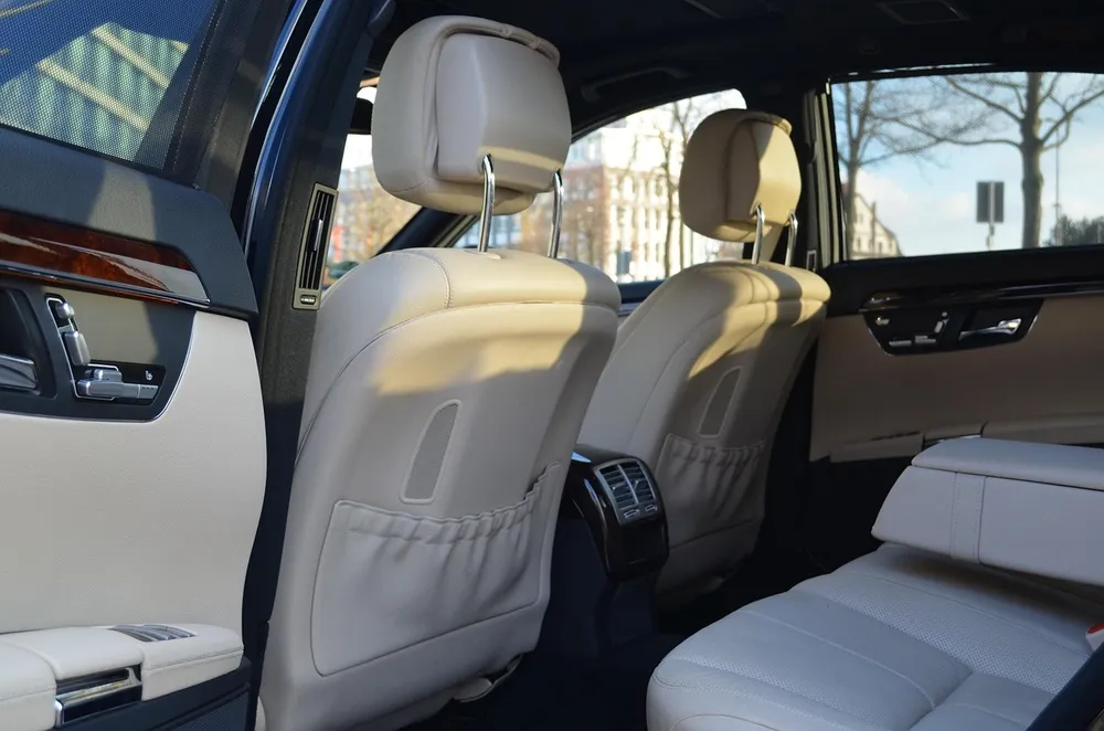 Rear seats of a luxury sedan with cream leather