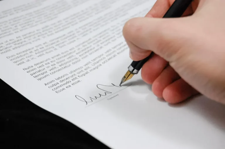 Signing a vehicle paperwork form with a fountain pen