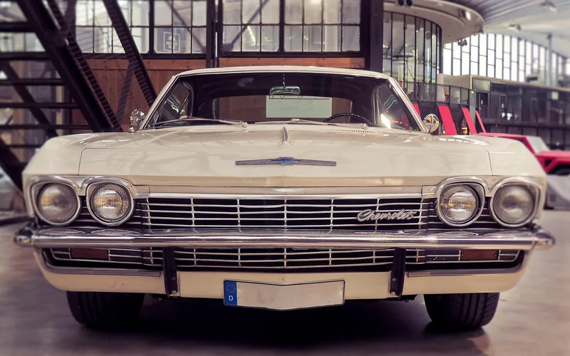 Front view of a classic cream-colored Chevrolet with chrome grille and Chevrolet badge
