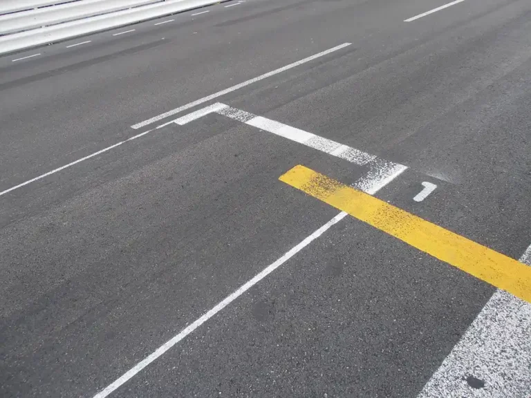 Painted start line markings on a race track asphalt surface