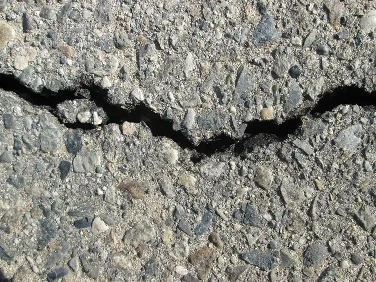 Close-up of a crack in an asphalt road surface