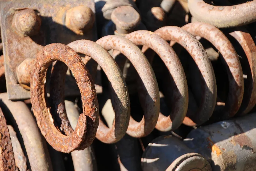 Rusted steel coil springs in a scrap pile