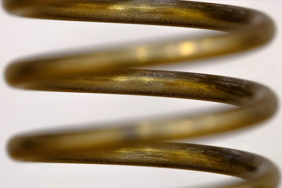 Close-up of a brass-colored coil spring