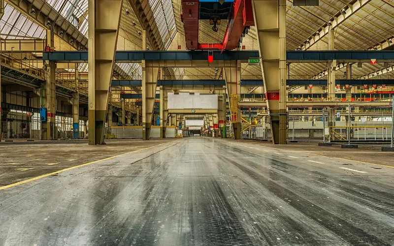 Empty industrial assembly line hall inside a large automotive factory