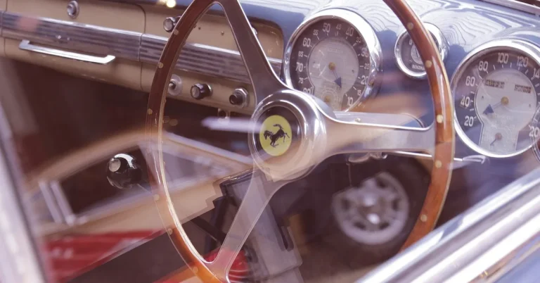 Vintage Ferrari steering wheel with the prancing horse badge and analog gauges