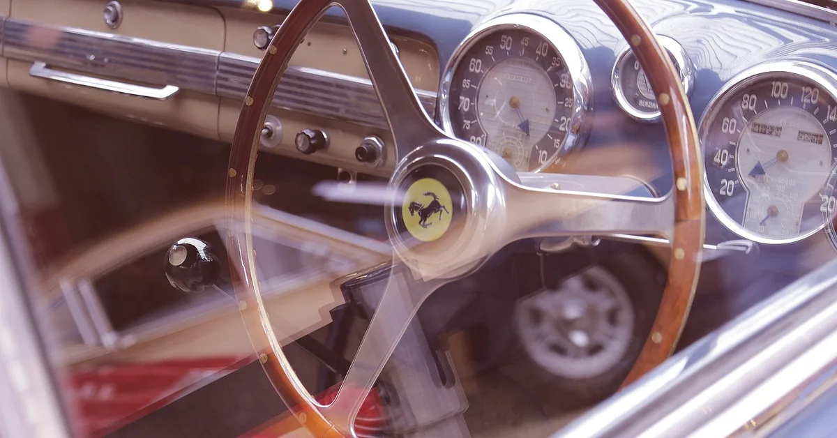 Vintage Ferrari steering wheel with the prancing horse badge and analog gauges