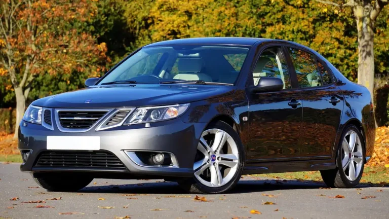 Dark grey Saab 9-3 sedan parked on a road in autumn
