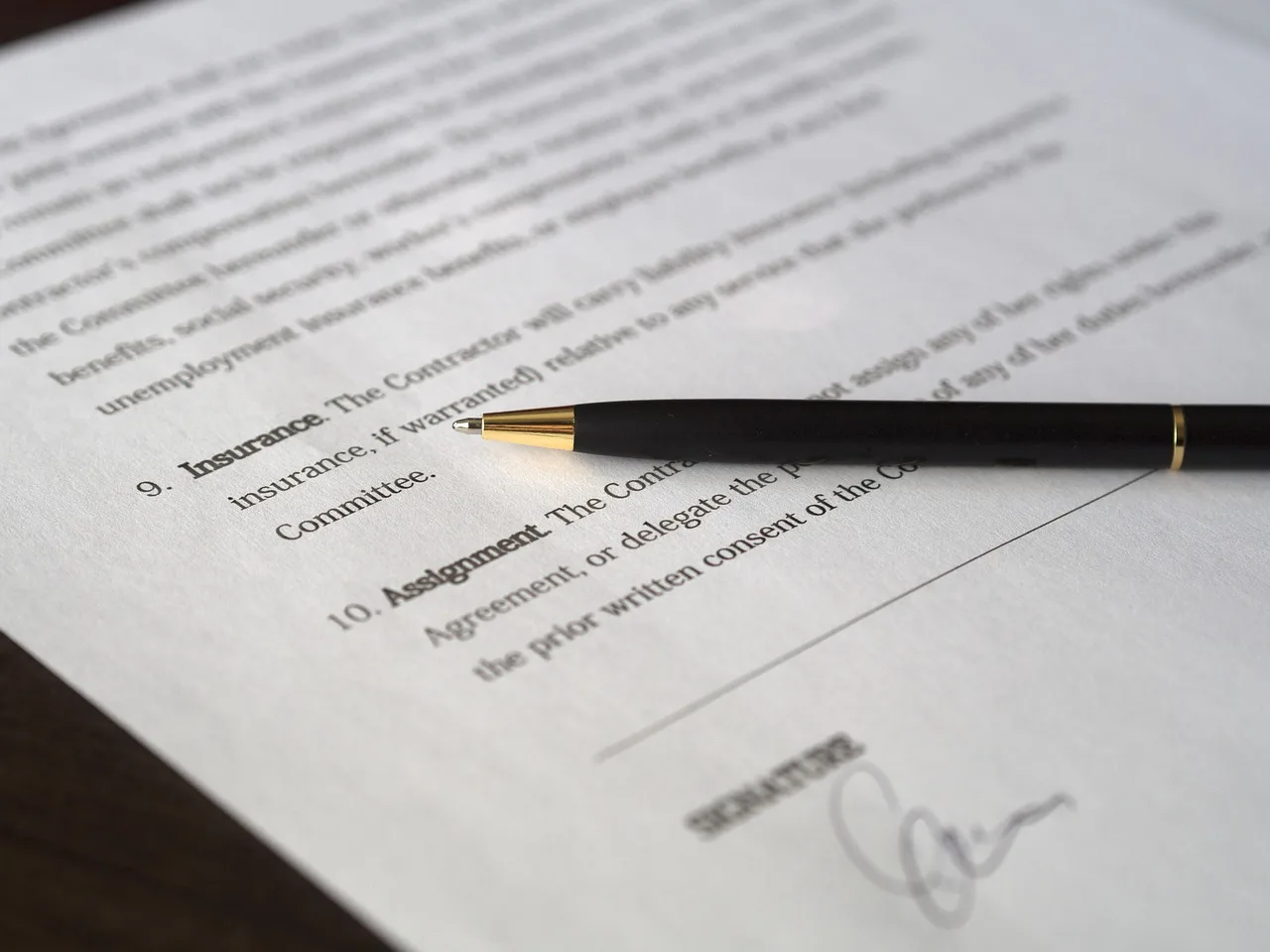 Signing a title transfer and registration form at the DMV