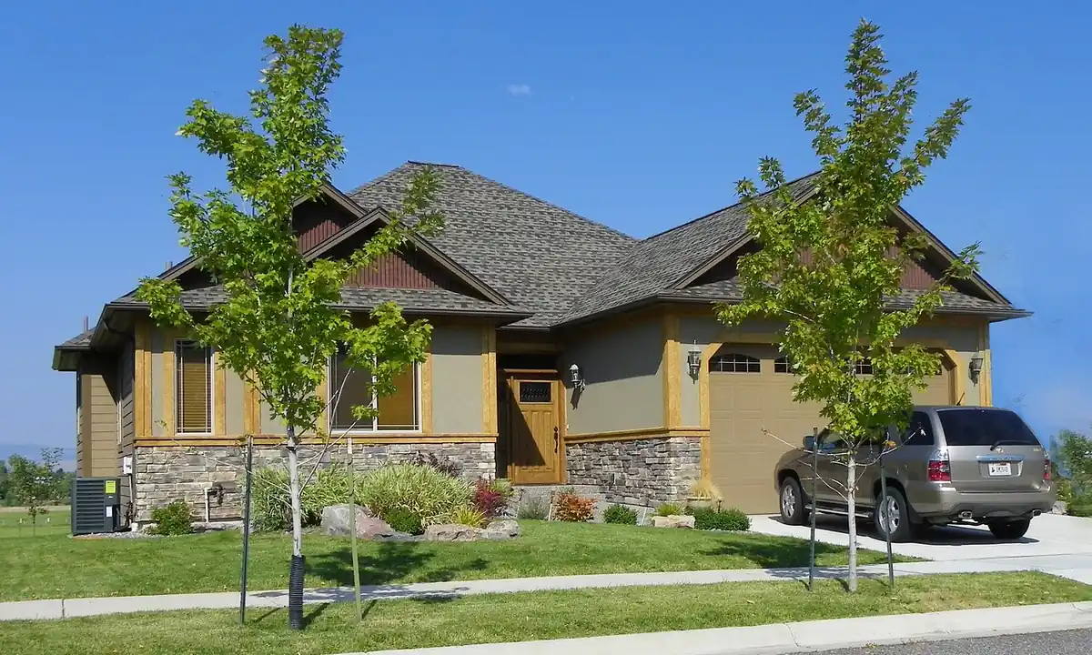 Suburban house with a garage and a car parked on the driveway