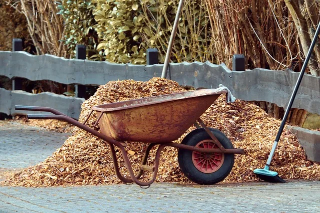 Wood mulch bed next to a paved driveway where a car is parked