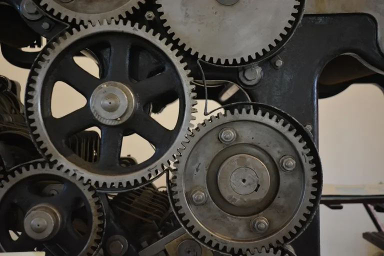 Close-up of large metal spur gears with bolted hubs