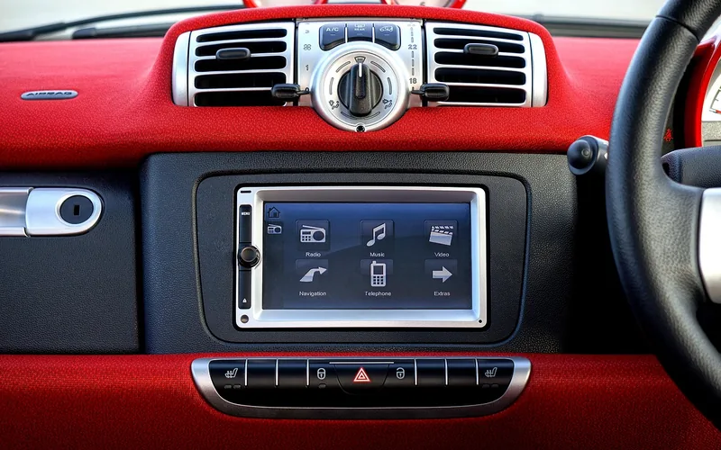 car dashboard with a small AIRBAG label above the center air vents next to the steering wheel car dashboard with a small AIRBAG label above the center air vents next to the steering wheel