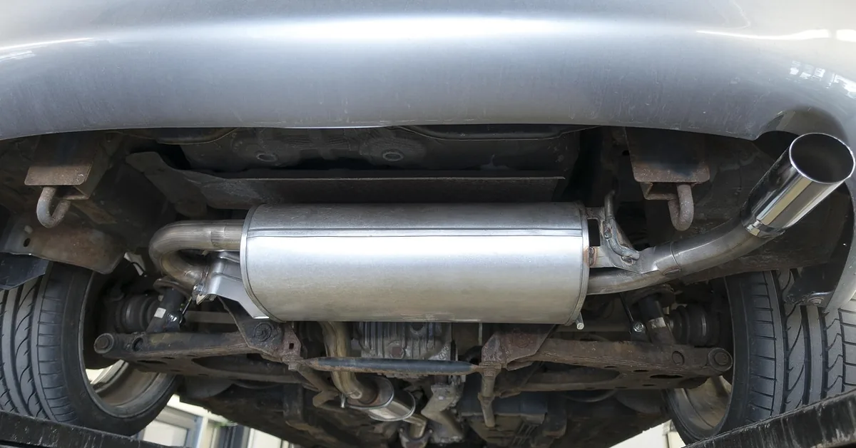 Underside of a car showing the muffler and tailpipe of the exhaust system