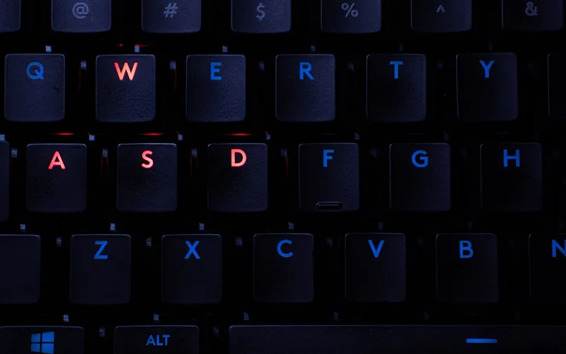 Backlit RGB WASD keys on a PC gaming keyboard used to play Car Mechanic Simulator
