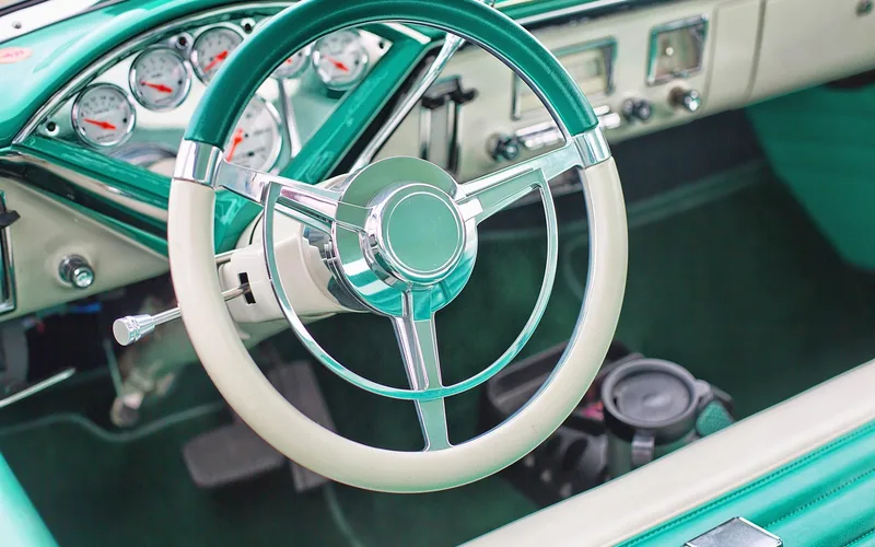Vintage car dashboard and steering wheel with chrome details evoking personality and character Vintage car dashboard and steering wheel with chrome details evoking personality and character