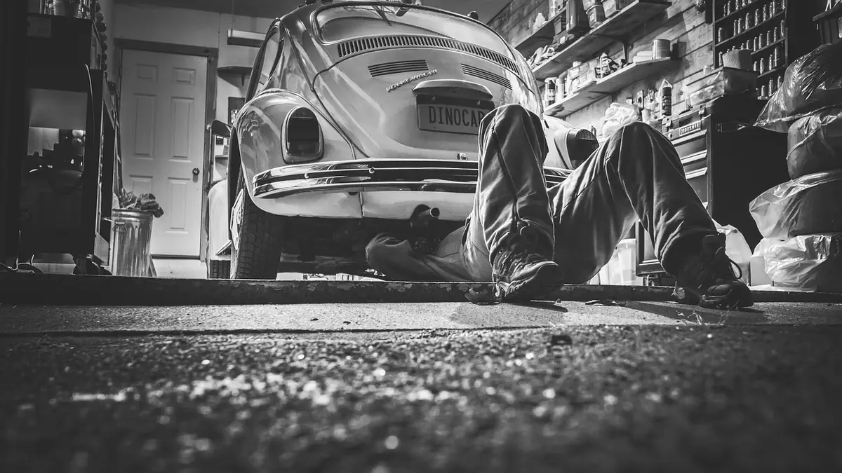 Mechanic reviewing a car maintenance checklist on a clipboard