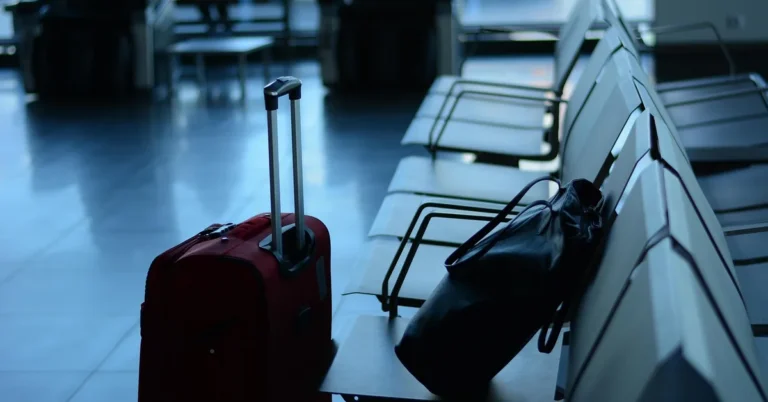 Suitcase and bag on airport waiting-area seats before picking up a rental car