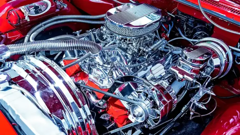 Chrome-plated engine compartment under the open hood of a red car