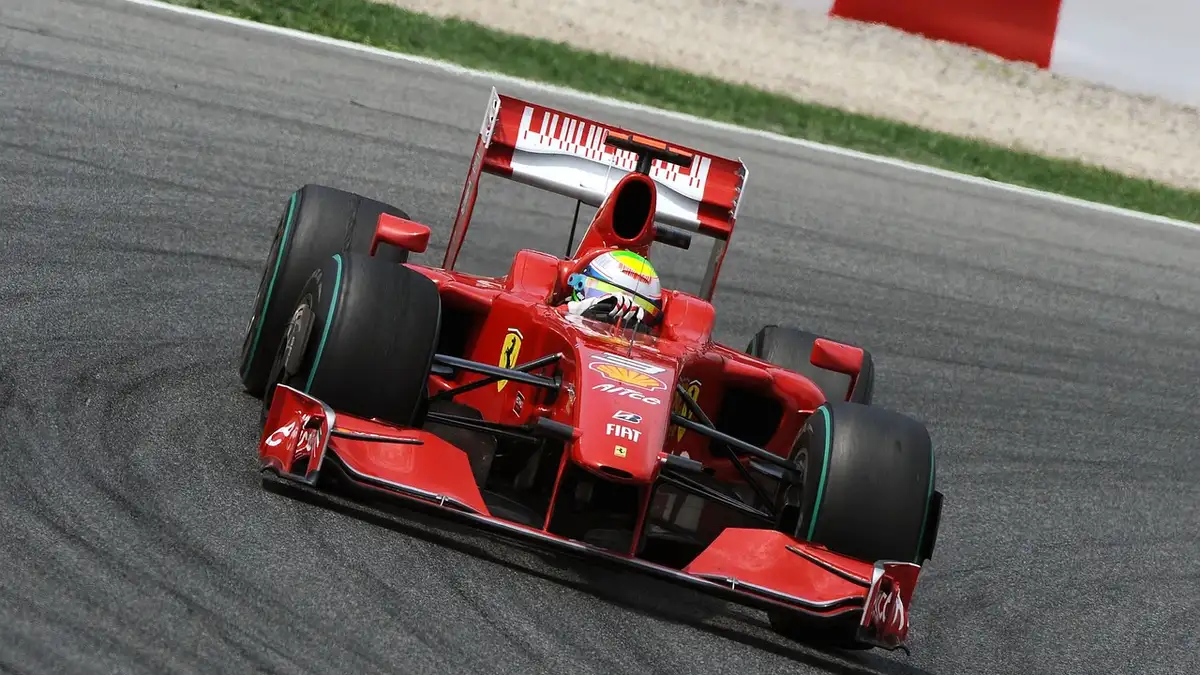 Modern high-performance racing car accelerating out of a corner