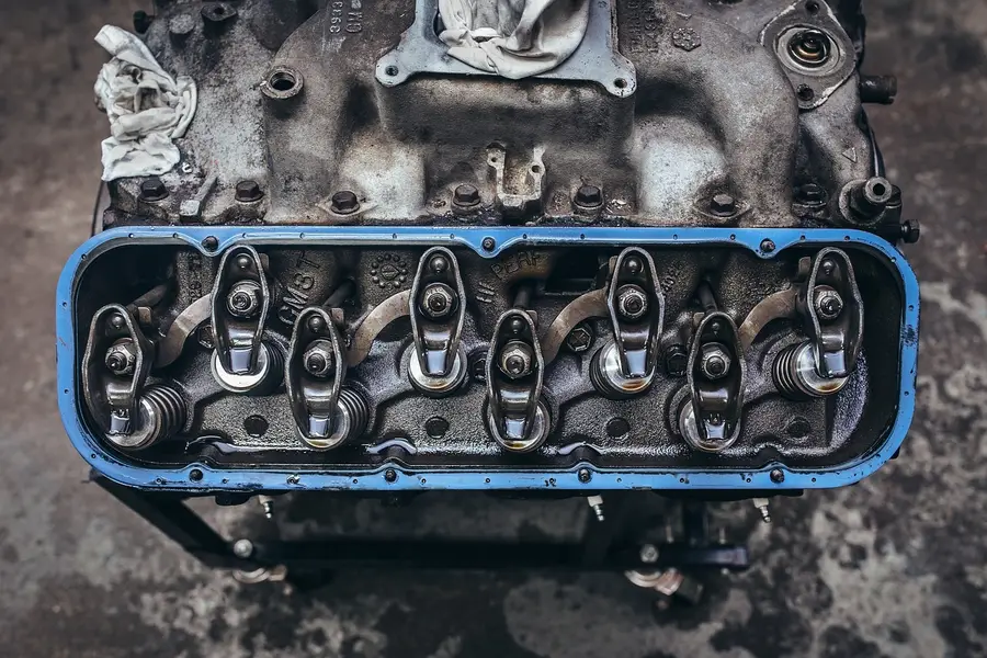 V8 engine with the valve cover removed showing rocker arms and valve springs on a stand