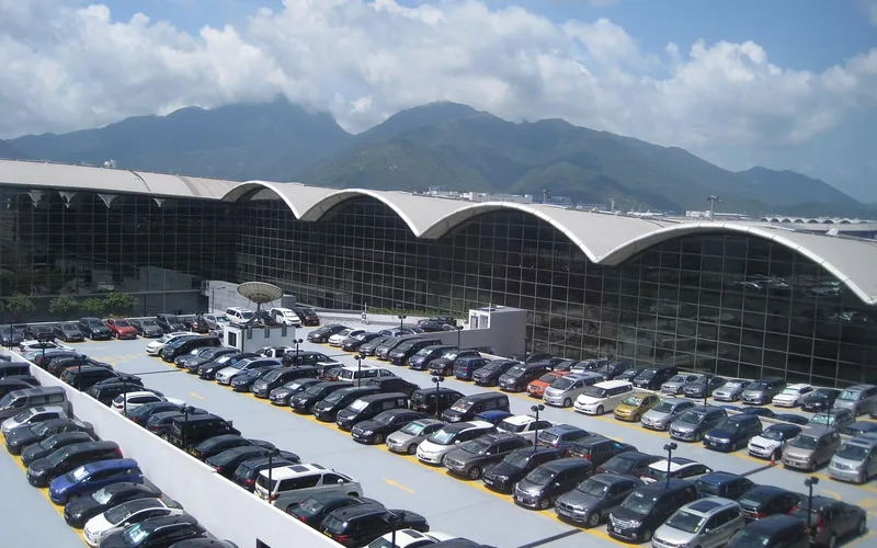 Large car park beside an airport terminal building