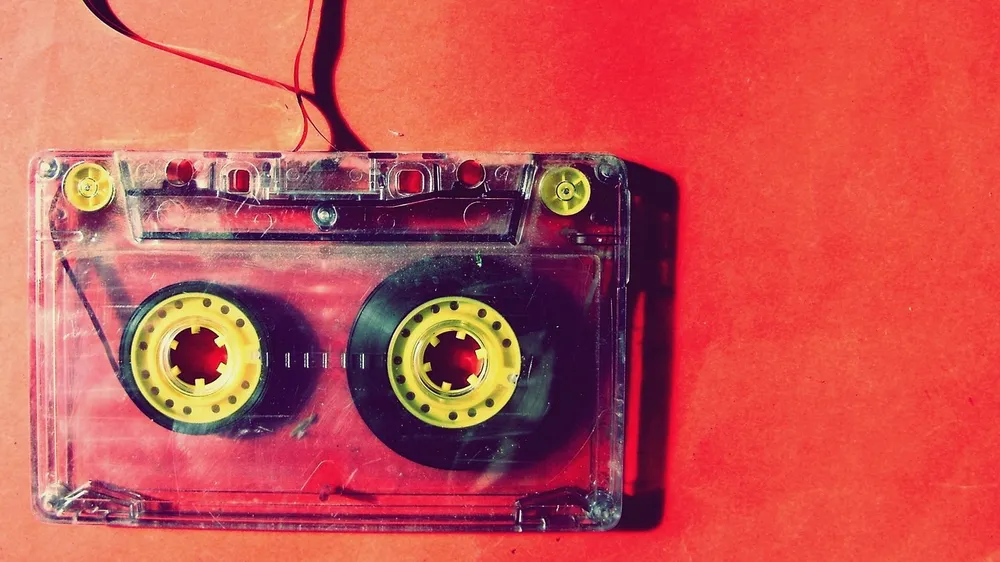 A standard audio cassette, the same shape as a car cassette adapter
