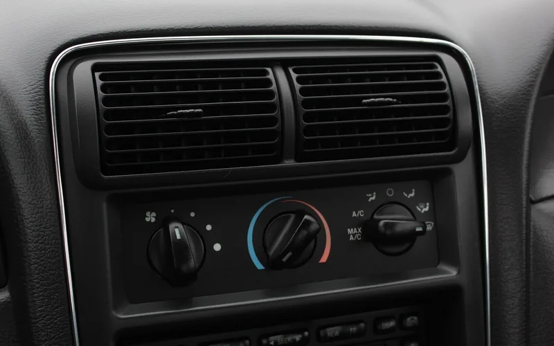 Car dashboard vents with heater and A/C control knobs