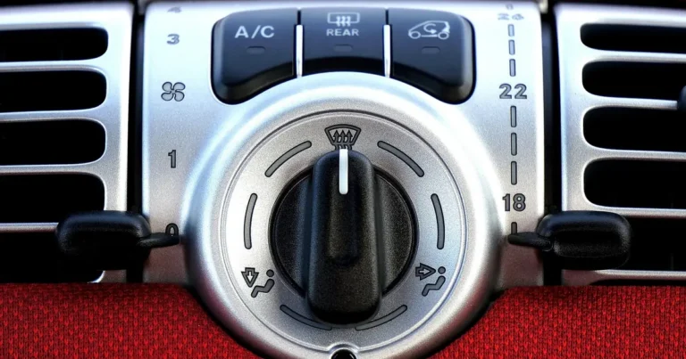 Car air conditioning control panel with A/C button and dashboard vents