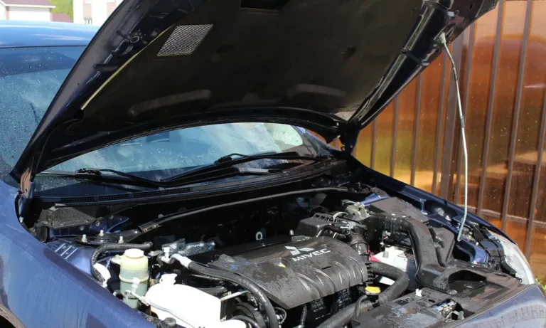 Car with the hood open showing the engine bay and radiator area