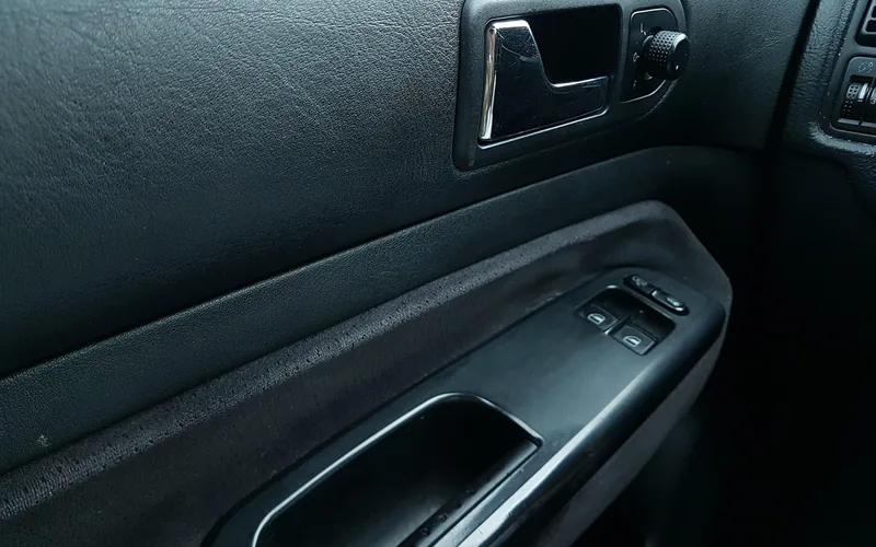 Interior car door panel with door handle and window switches