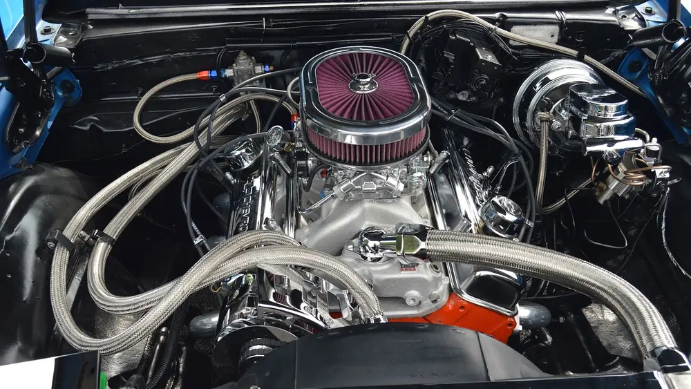 Chrome small-block V8 engine bay in a classic Chevrolet muscle car