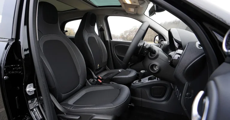 Clean black front seats and dashboard seen through an open car door
