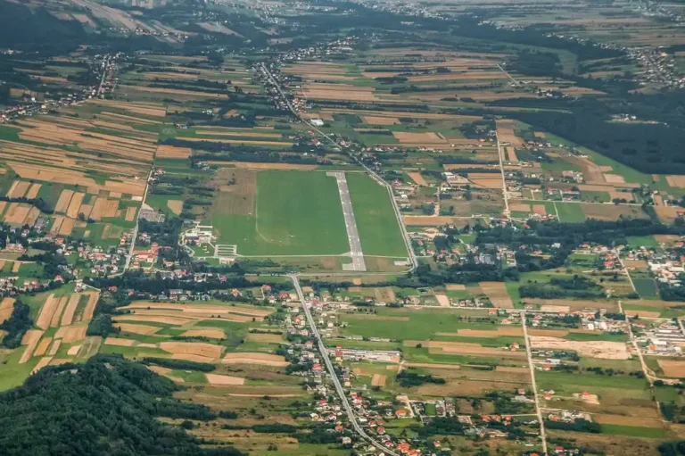 Aerial view of an airfield runway surrounded by farmland and villages