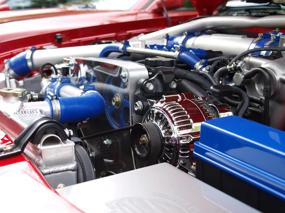 Drive belt, pulley and alternator in a car engine bay