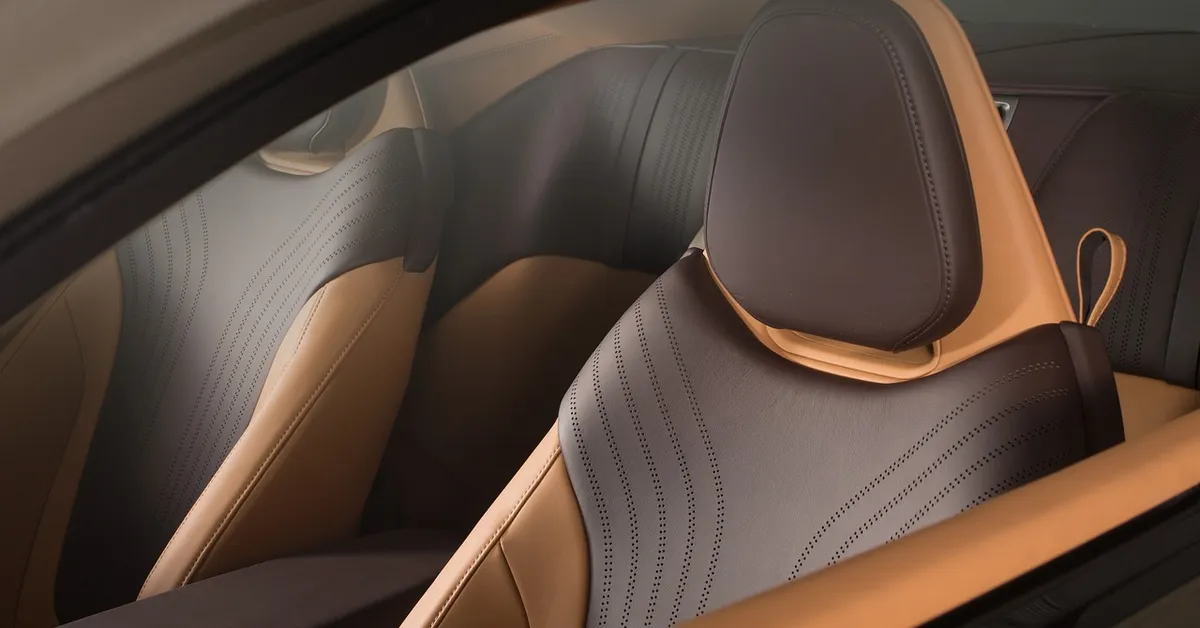 Front and rear leather seats of a car seen through the side window