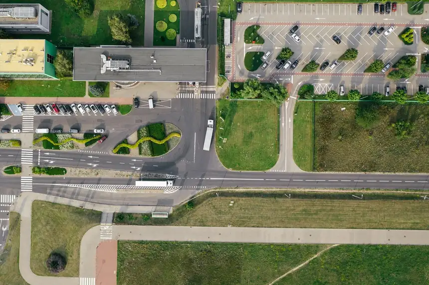 Top-down drone photo of a road and parking lots