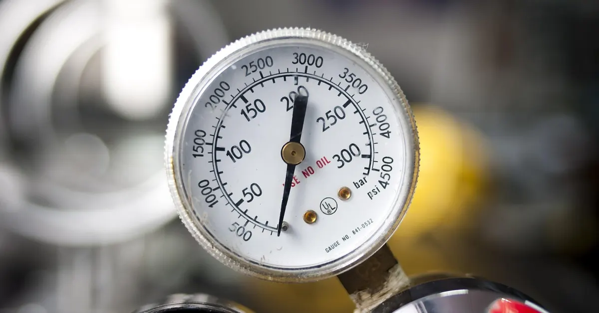 Close-up of a round pressure gauge dial with a psi scale