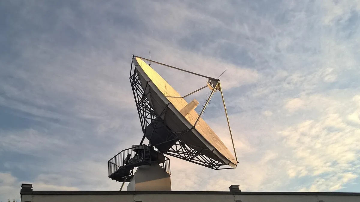 Satellite dish antenna pointed at the sky, the kind of ground link satellite radio depends on