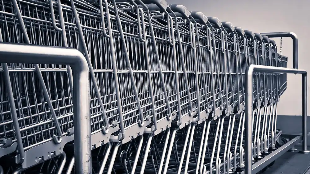 Row of nested shopping carts outside a warehouse-style store