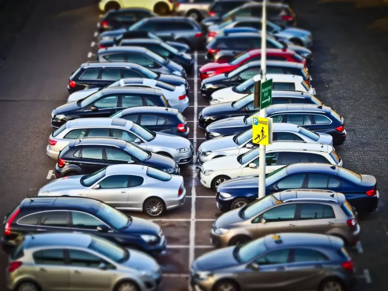 Rows of parked cars in a lot seen from above