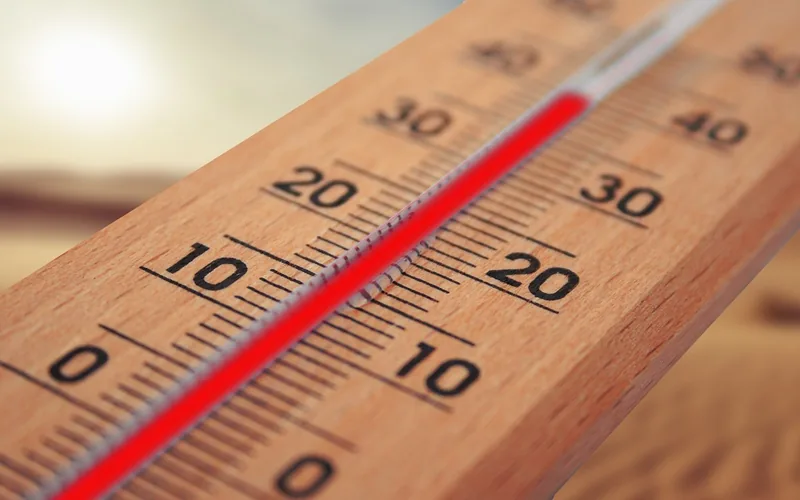 Wooden thermometer with a red column showing a hot day