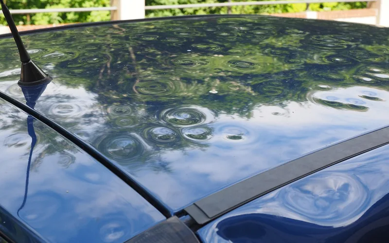 car roof with hail dents showing paint damage and bumps from a hailstorm
